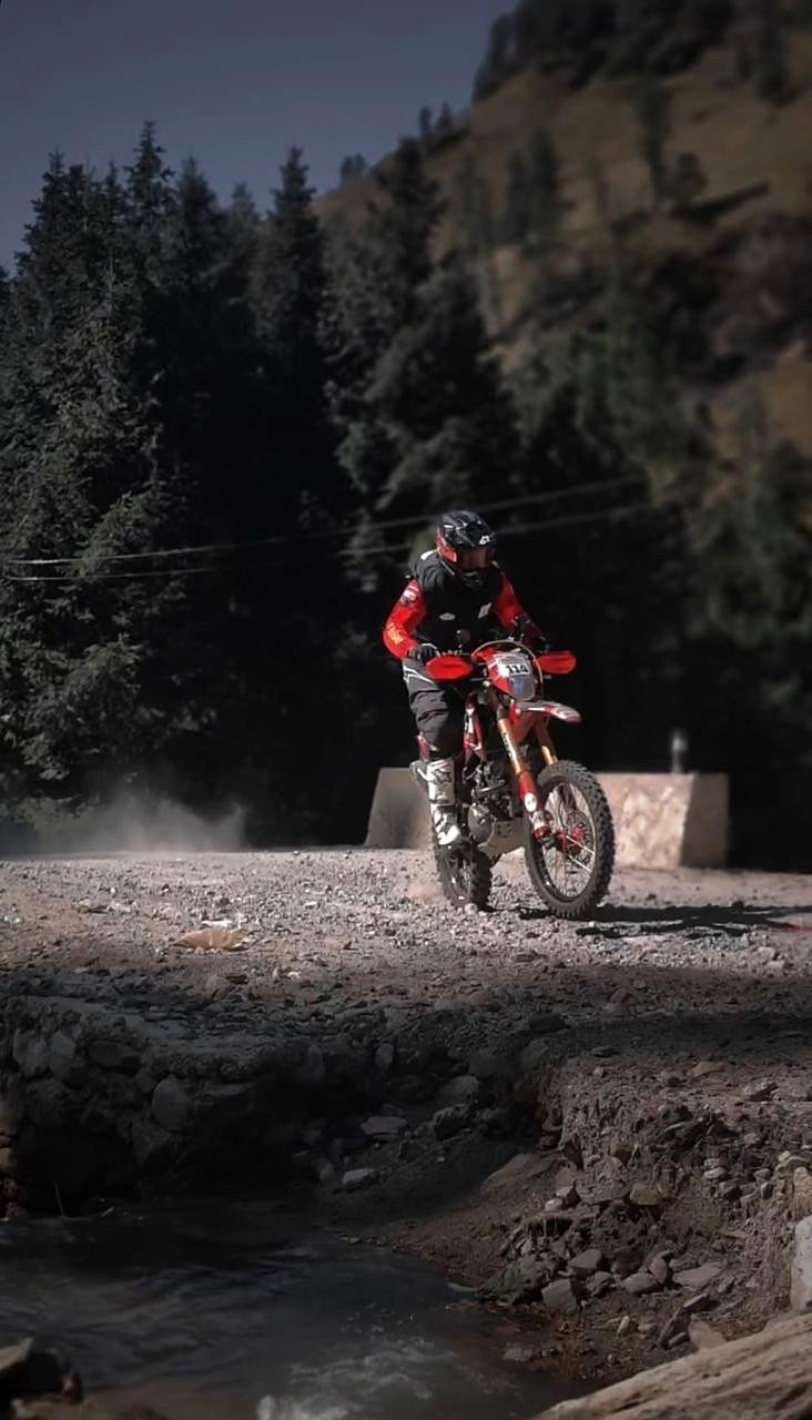 Leon Lhendup Wangdi crossing difficult terrain during a motorcycle rally
